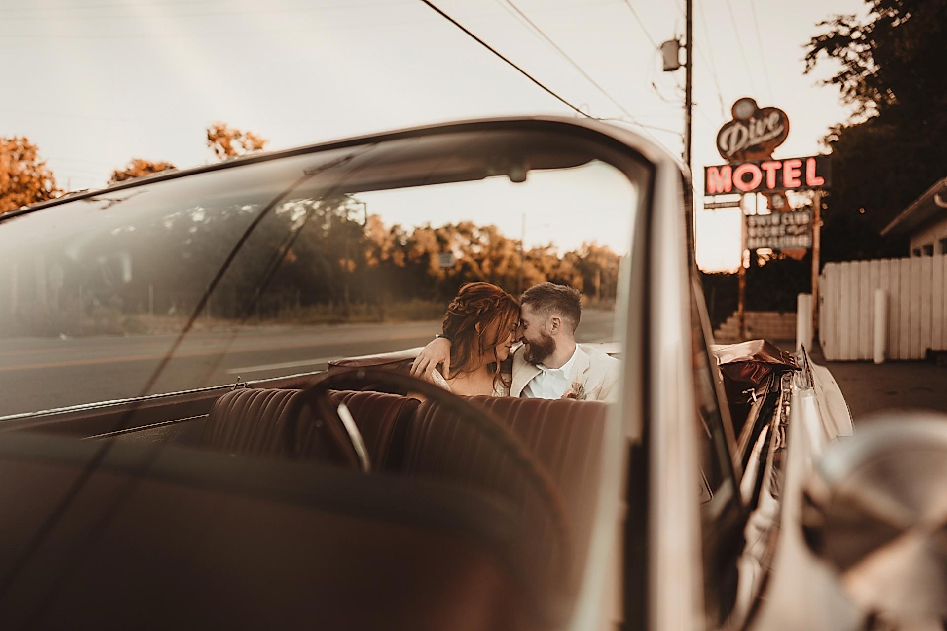 Just married couple sitting in classic car in Nashville USA
